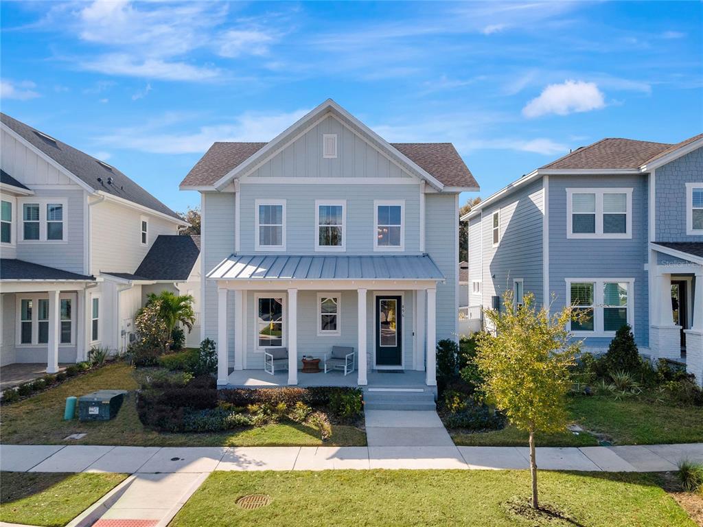 a front view of a house with yard and green space