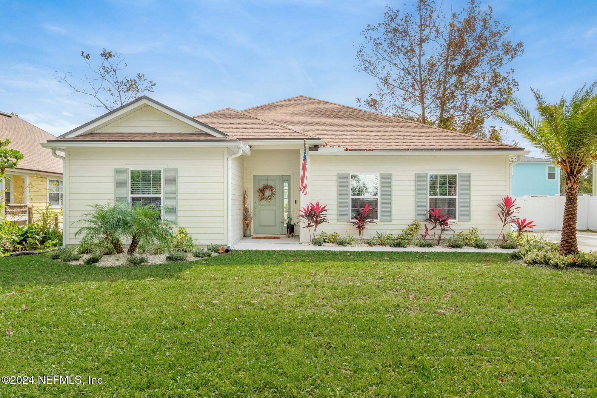 a front view of a house with a garden