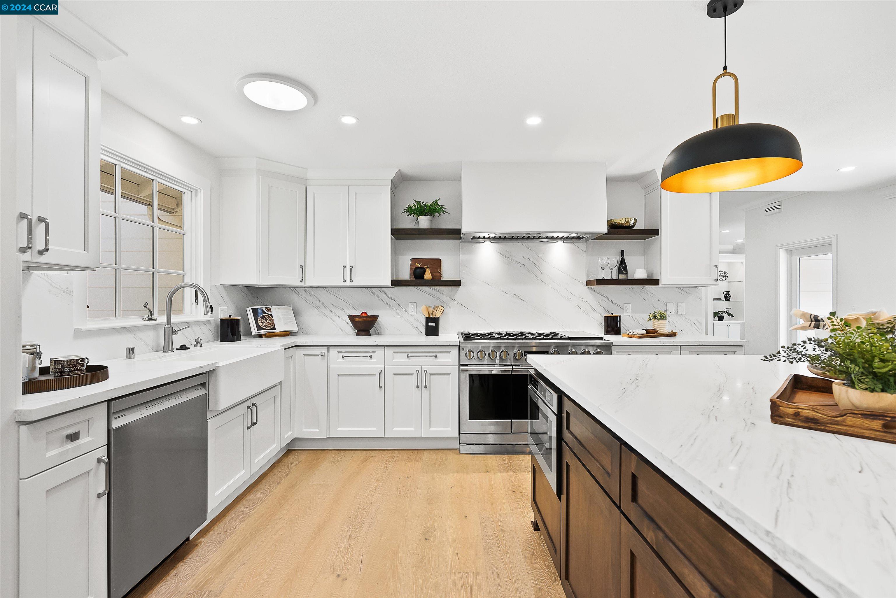 a kitchen with a sink a stove and cabinets