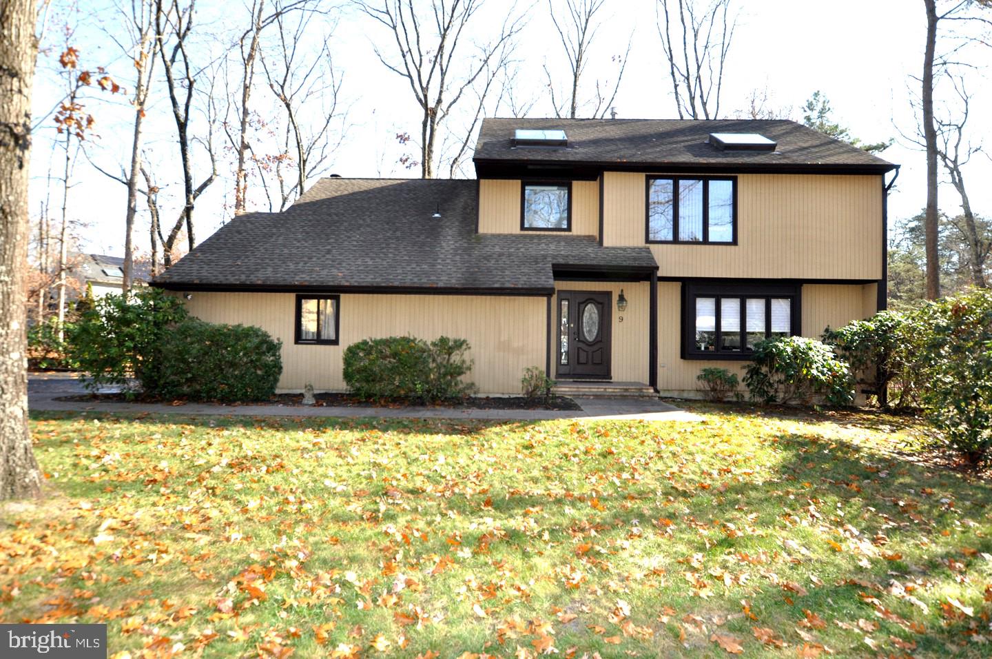 a house that has a large tree in front of it