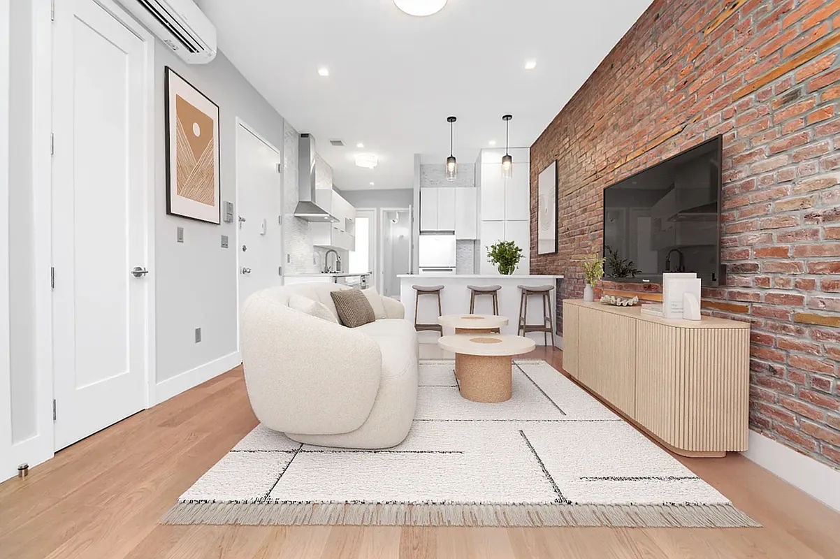 a living room with patio furniture and a flat screen tv