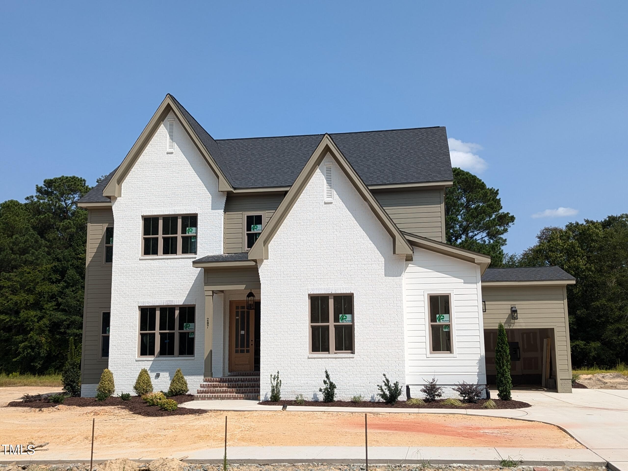 a view of a house with a yard and garage