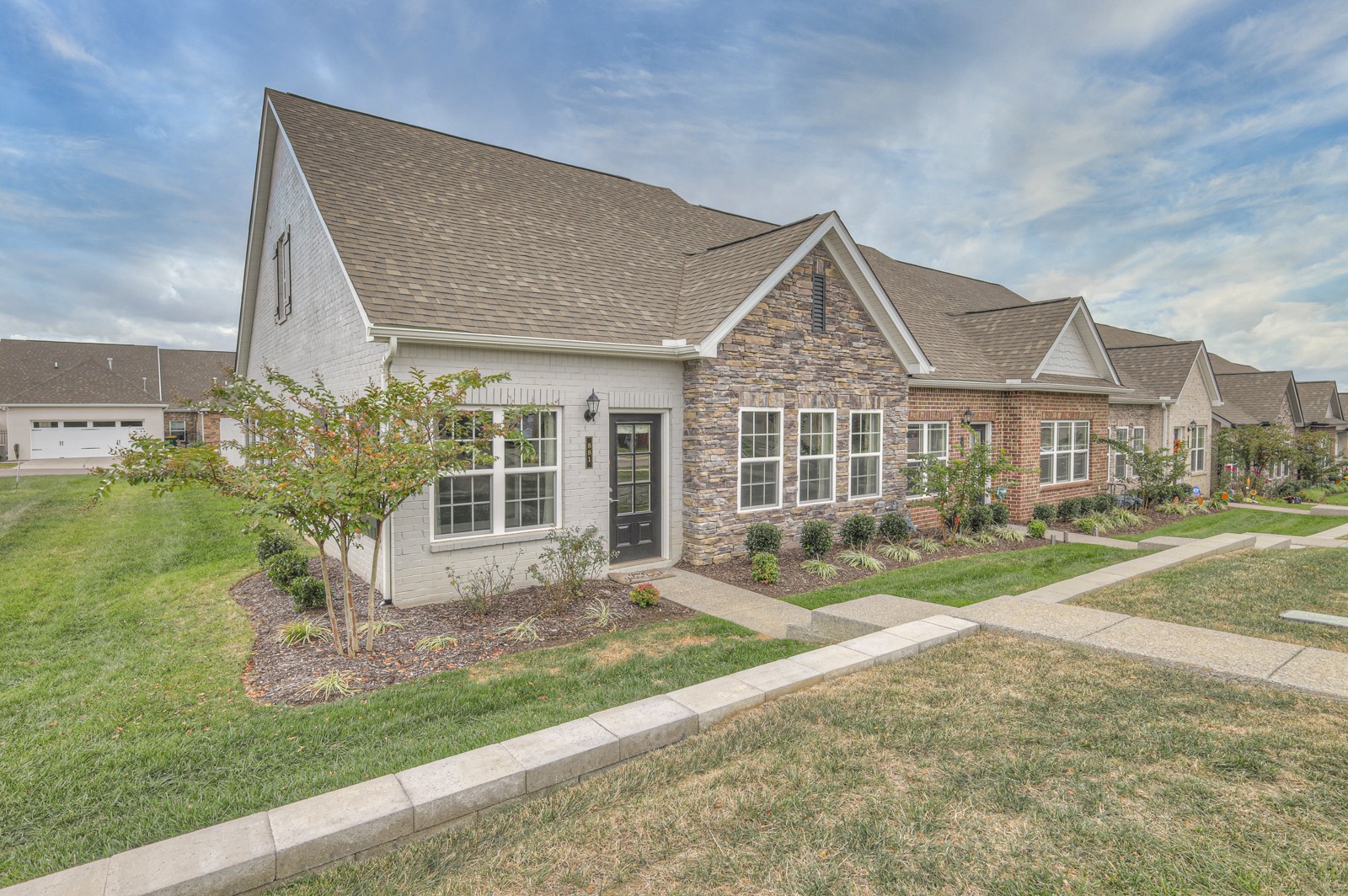 a front view of a house with a yard and porch