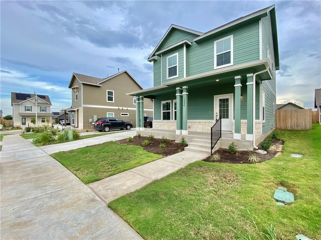 a front view of a house with a yard and porch