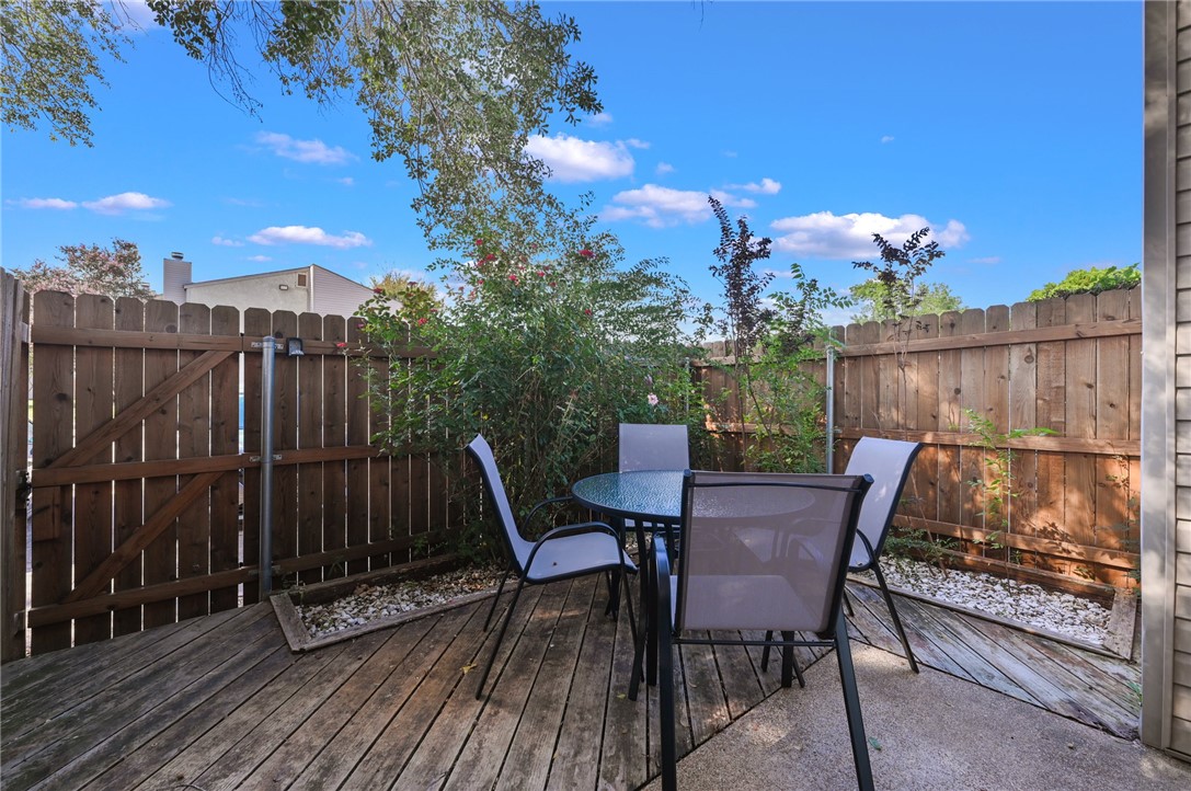 a view of a chairs and table on the roof deck