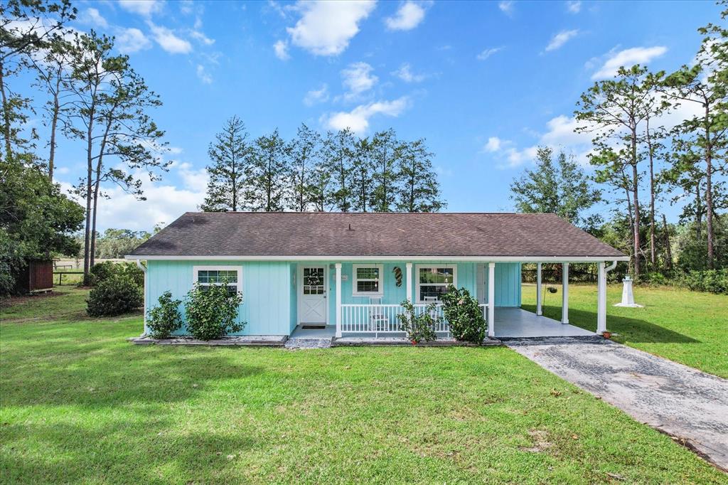 a view of a house with a backyard