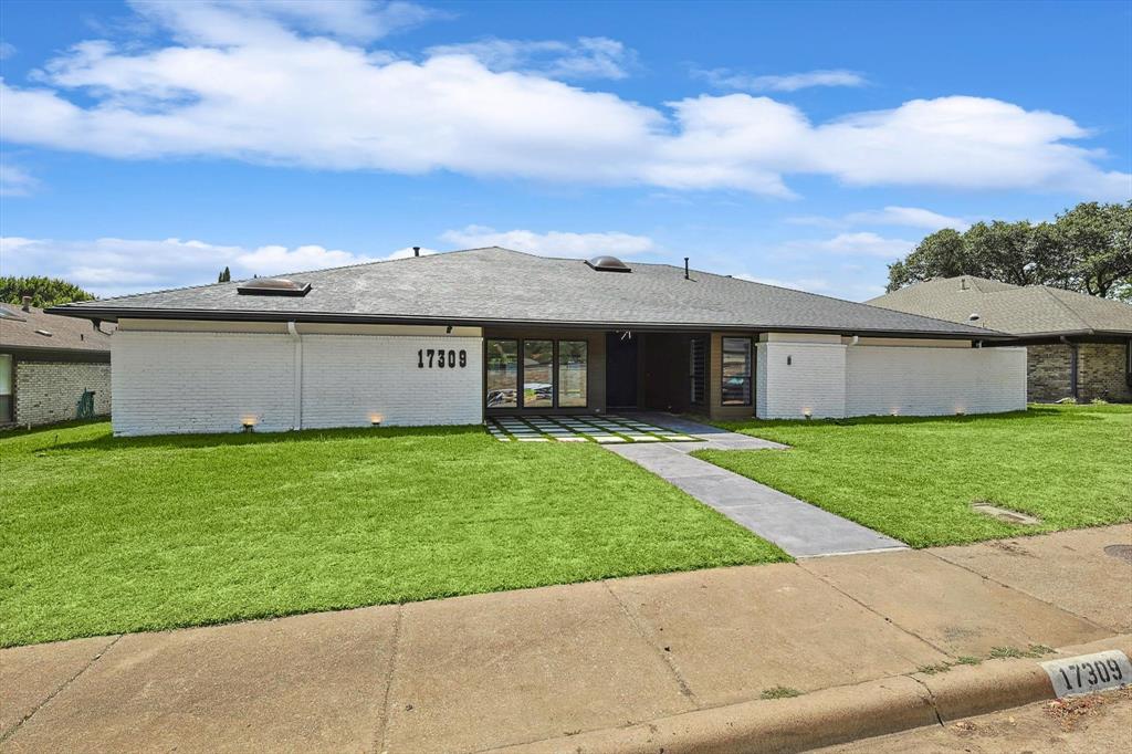 front view of a house with a garden