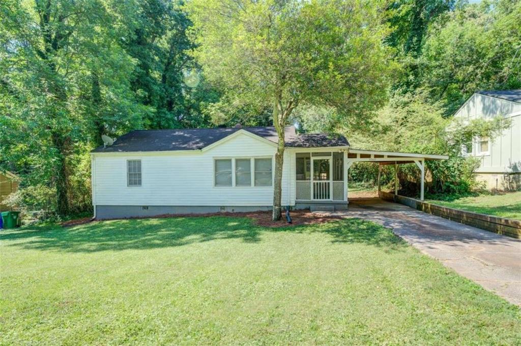 a view of a house with a yard and sitting area