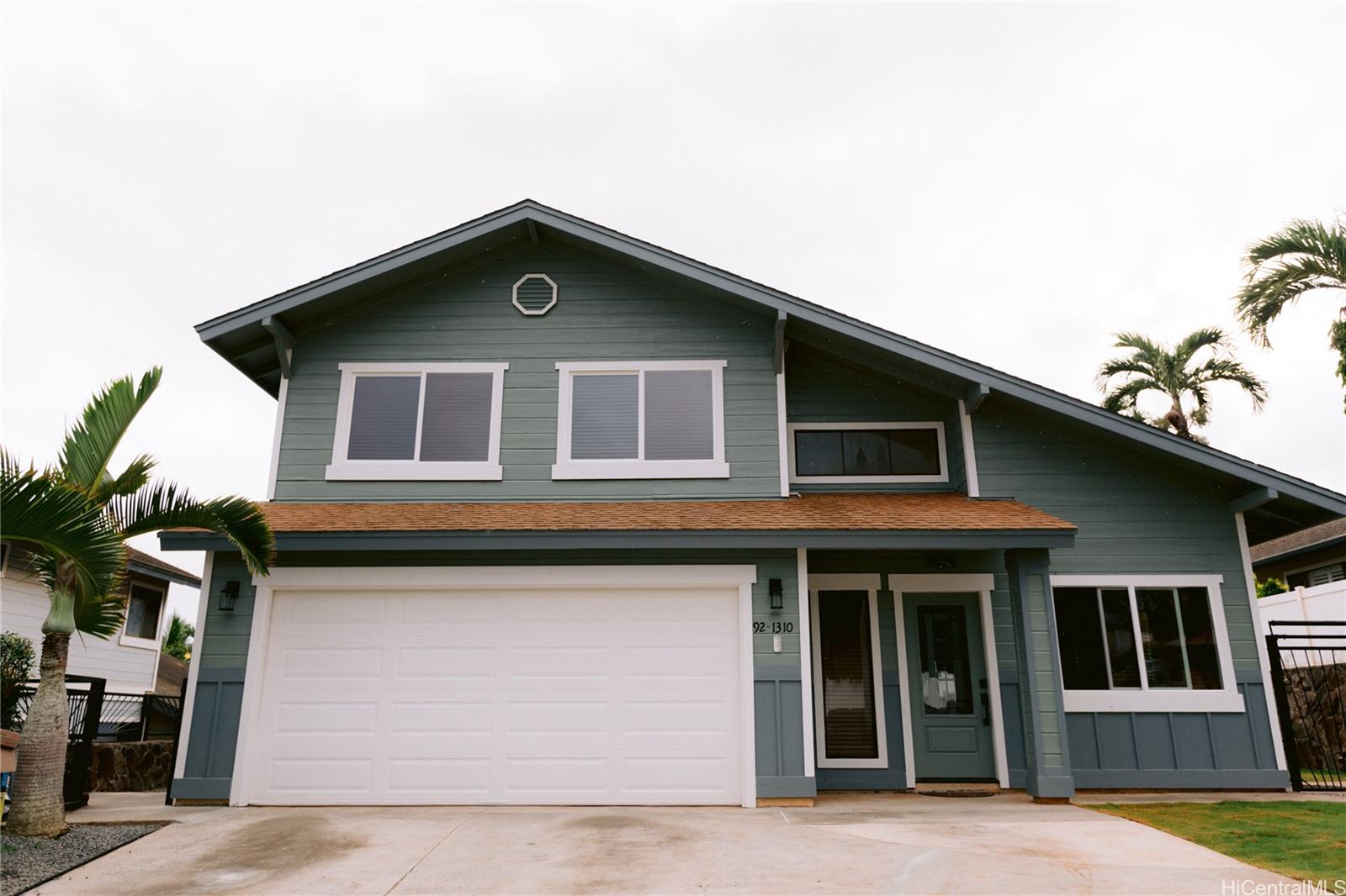 a front view of a house with garage