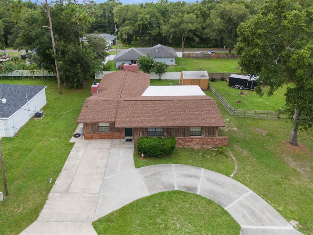 an aerial view of a house with swimming pool garden and patio