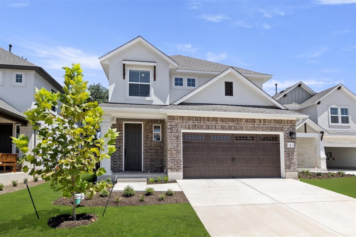 a front view of a house with a garden and yard