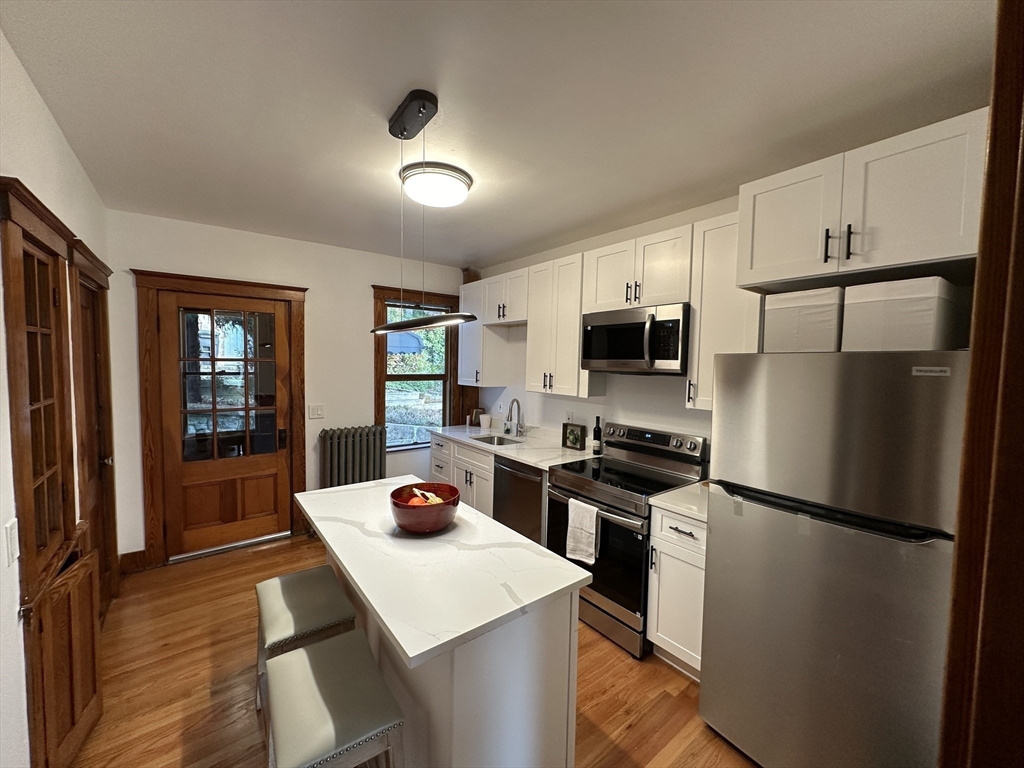 a kitchen with stainless steel appliances a refrigerator stove microwave and sink