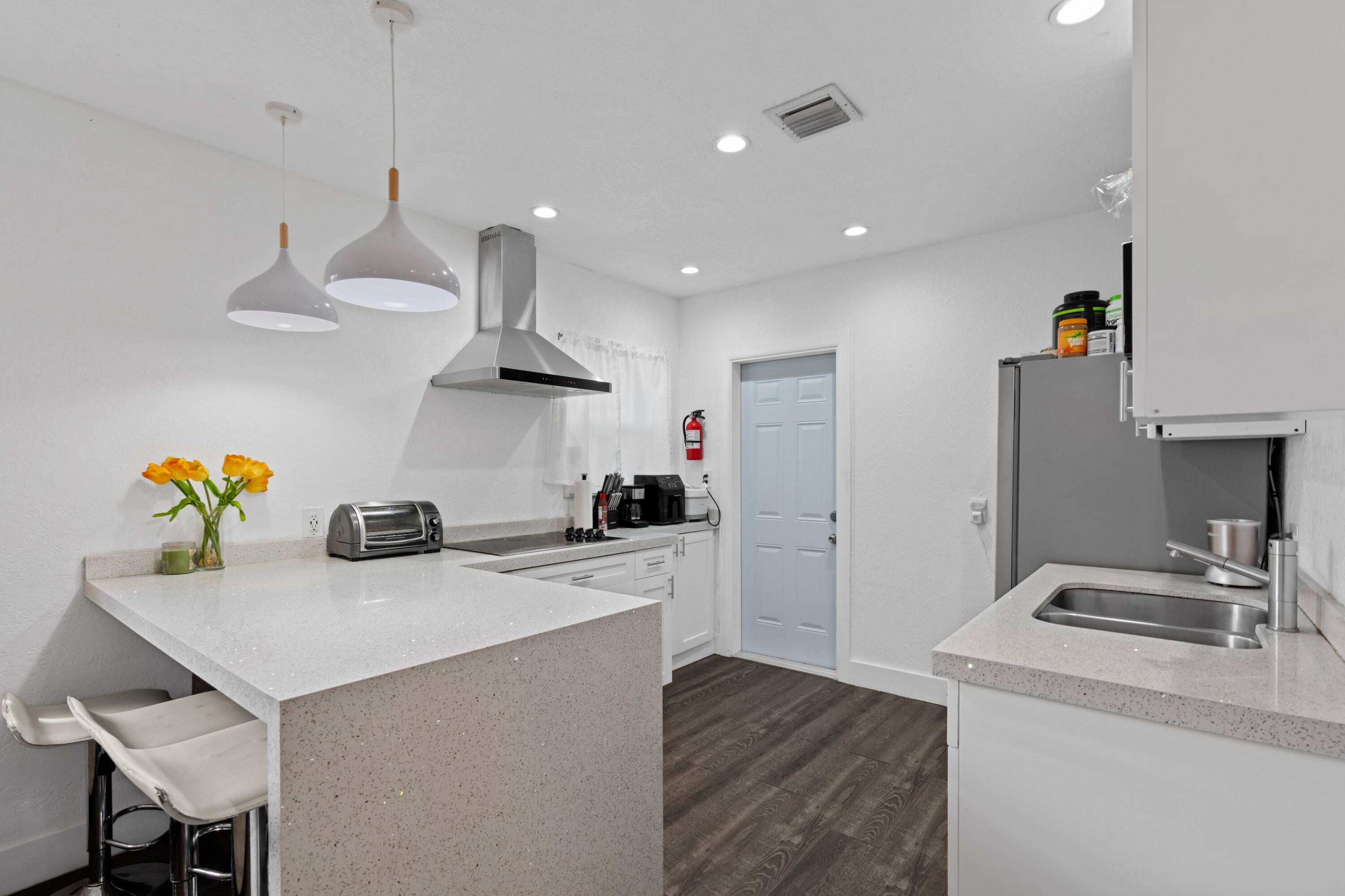 a kitchen with a sink a stove and refrigerator