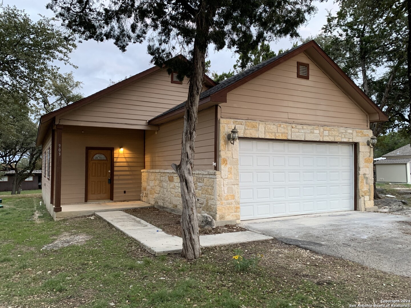 a front view of a house with a yard and garage