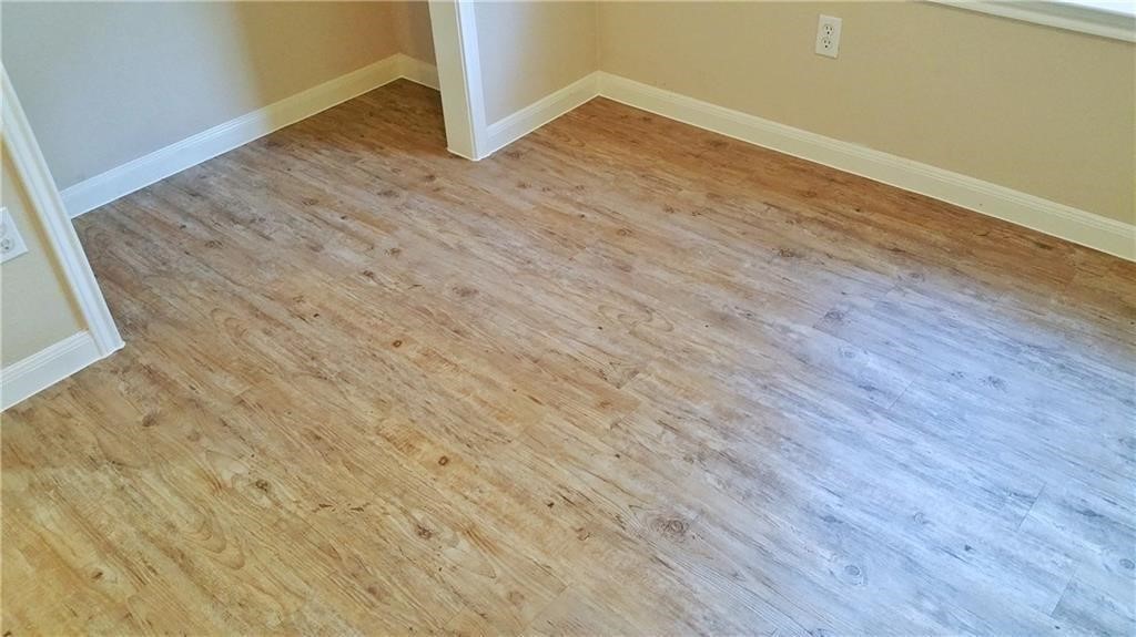 a view of a room with wooden floor