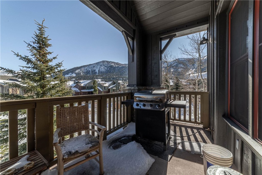 a balcony with wooden floor and outdoor seating