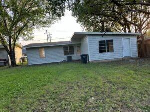 a front view of house with yard and trees