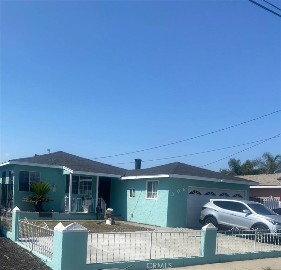 a front view of a house with parking area