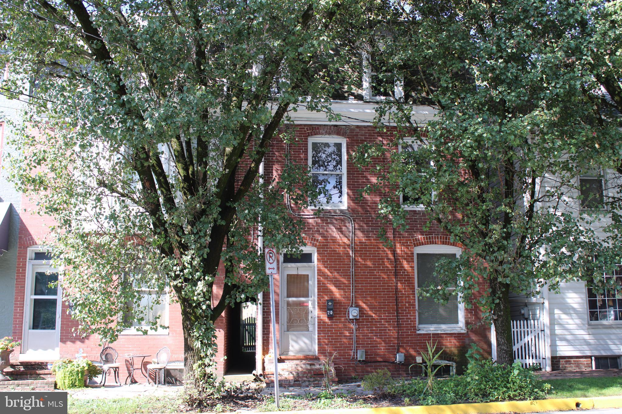 front view of a house with a tree