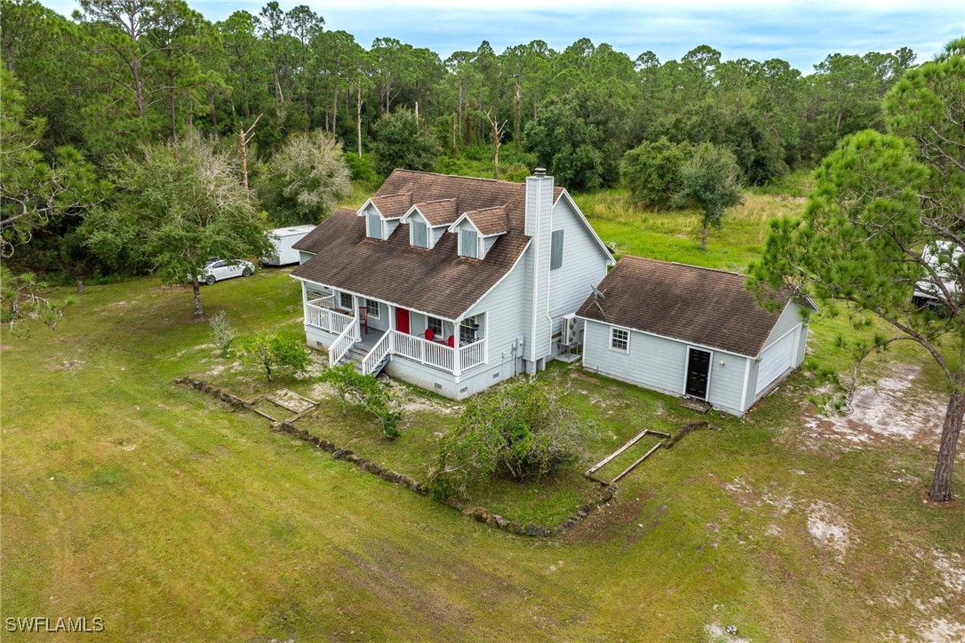 an aerial view of a house with swimming pool in front of it