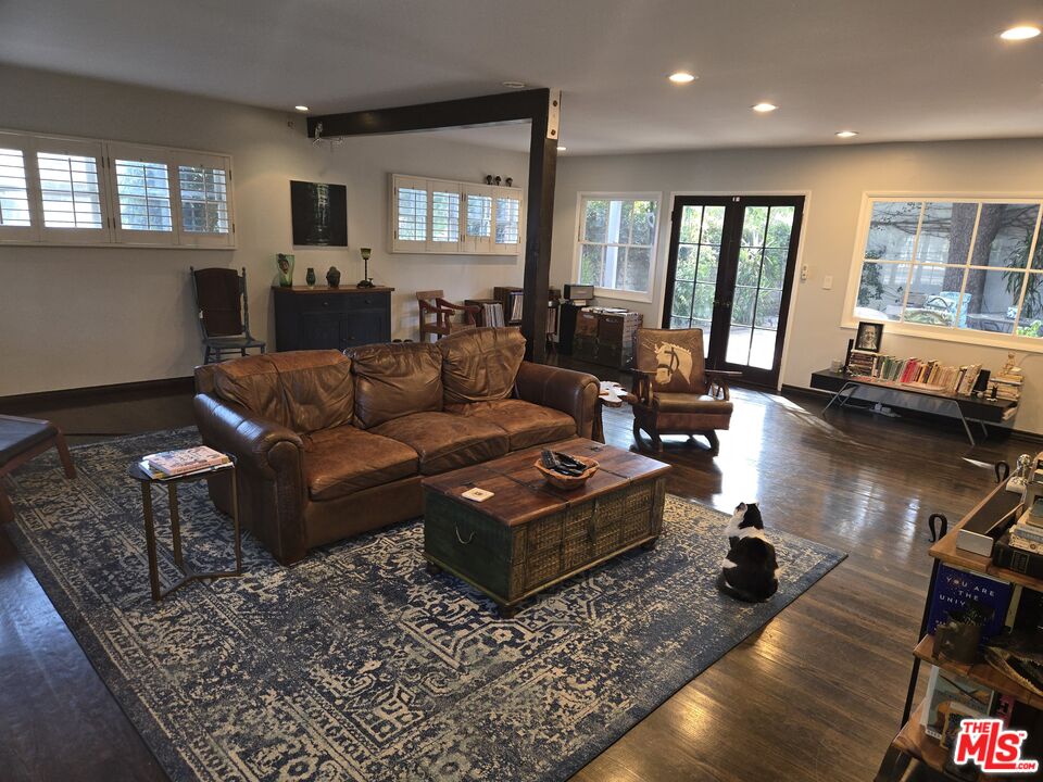 a living room with furniture rug and wooden floor