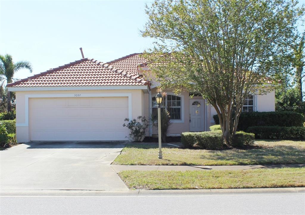 a front view of a house with a yard garage and outdoor seating