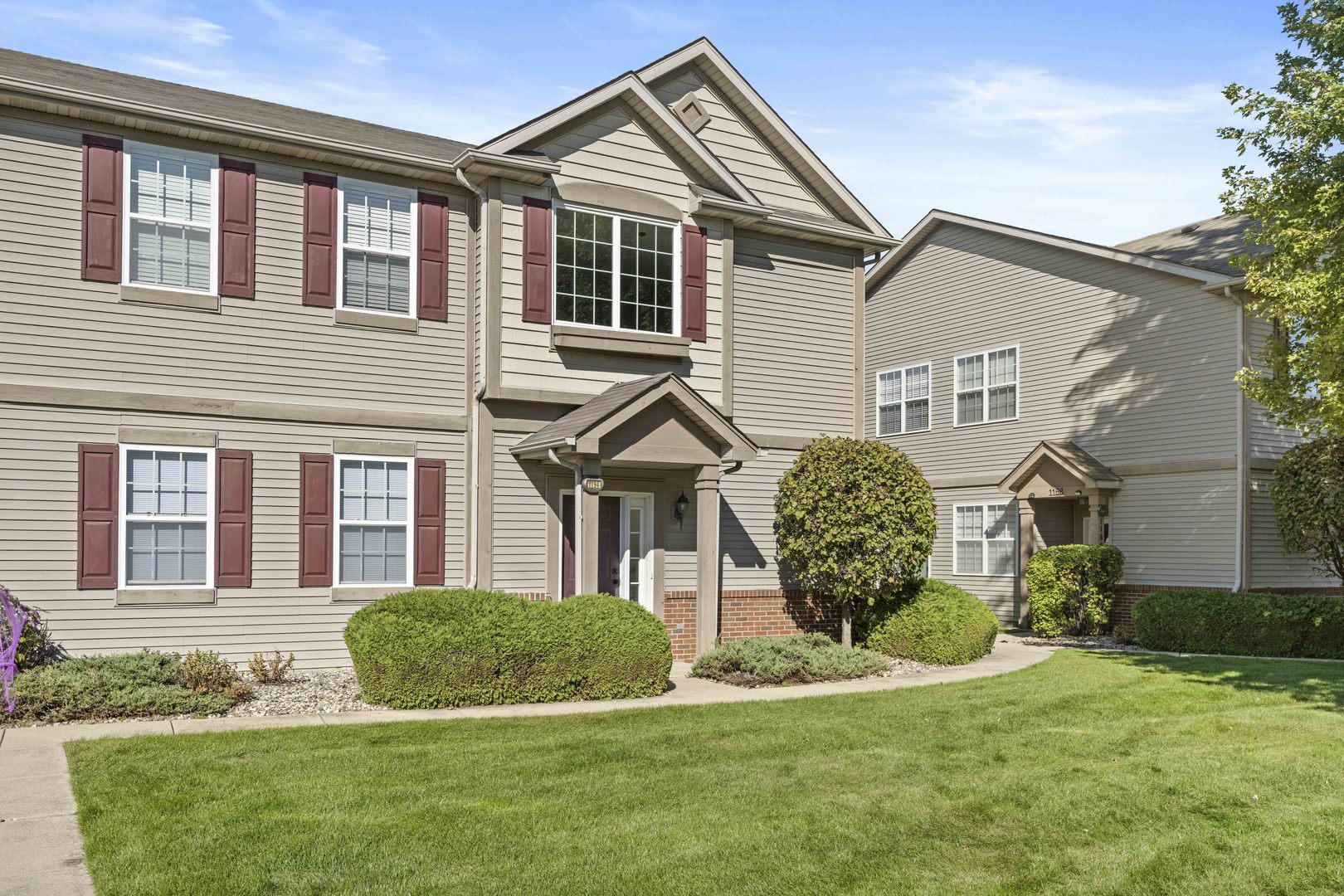 a front view of a house with a yard