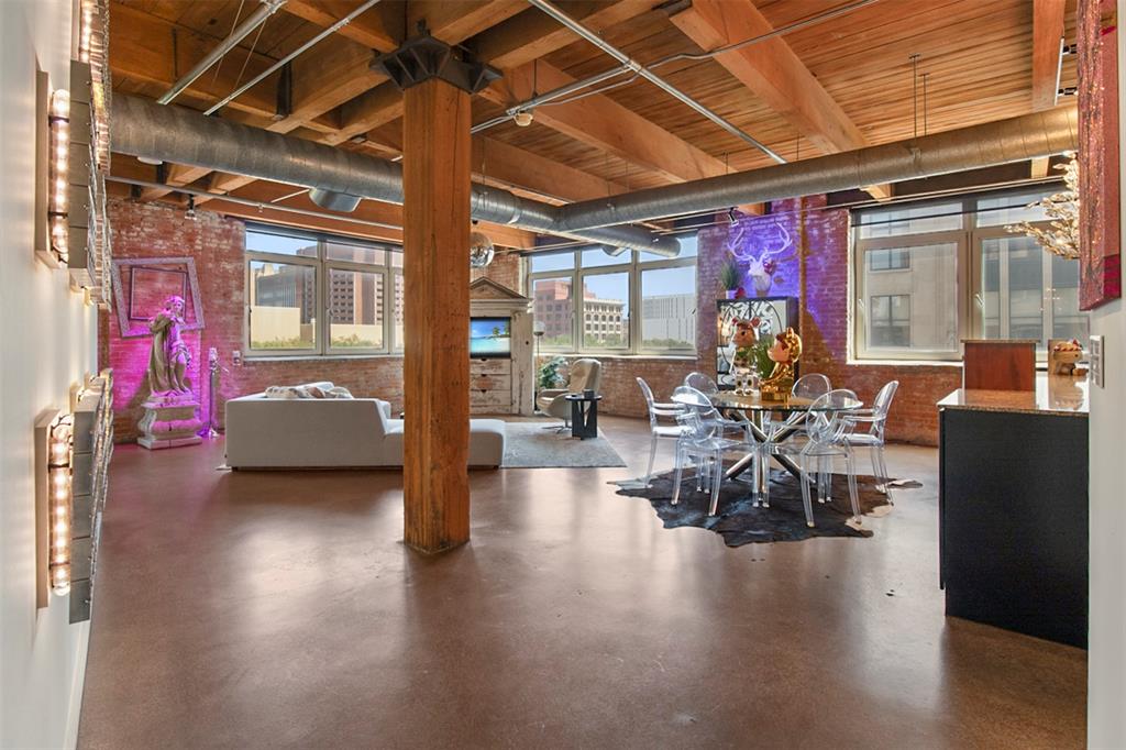 a hallway with a couch and chandelier