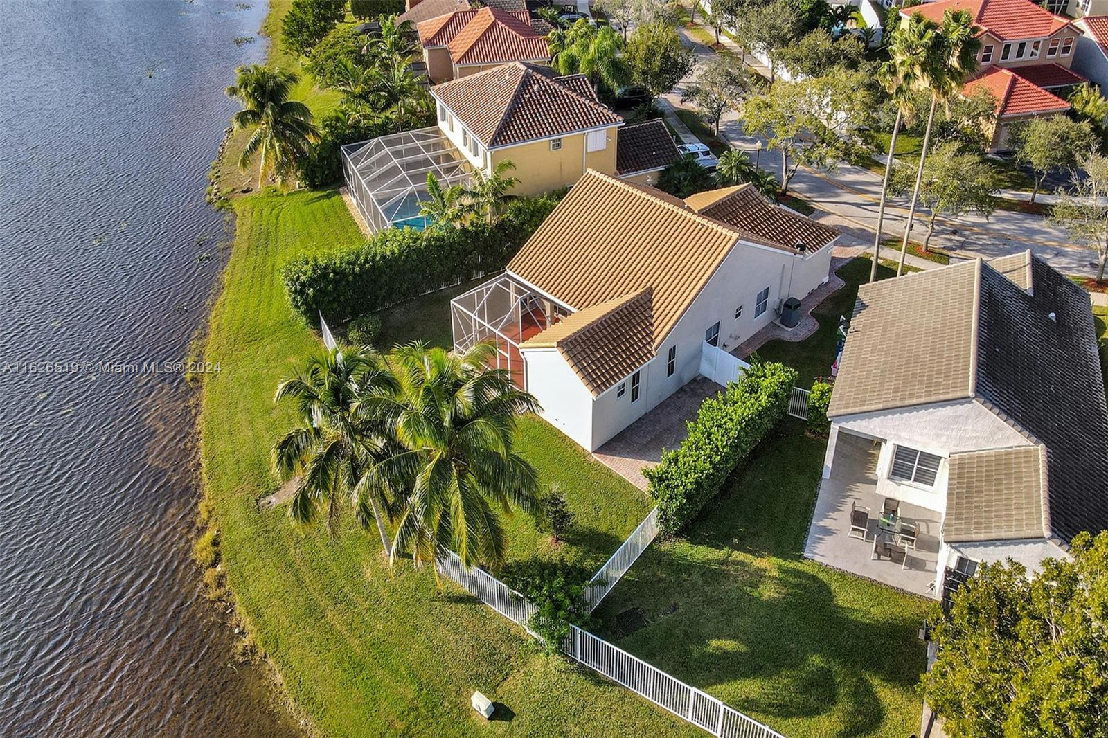 an aerial view of a house with a yard and swimming pool