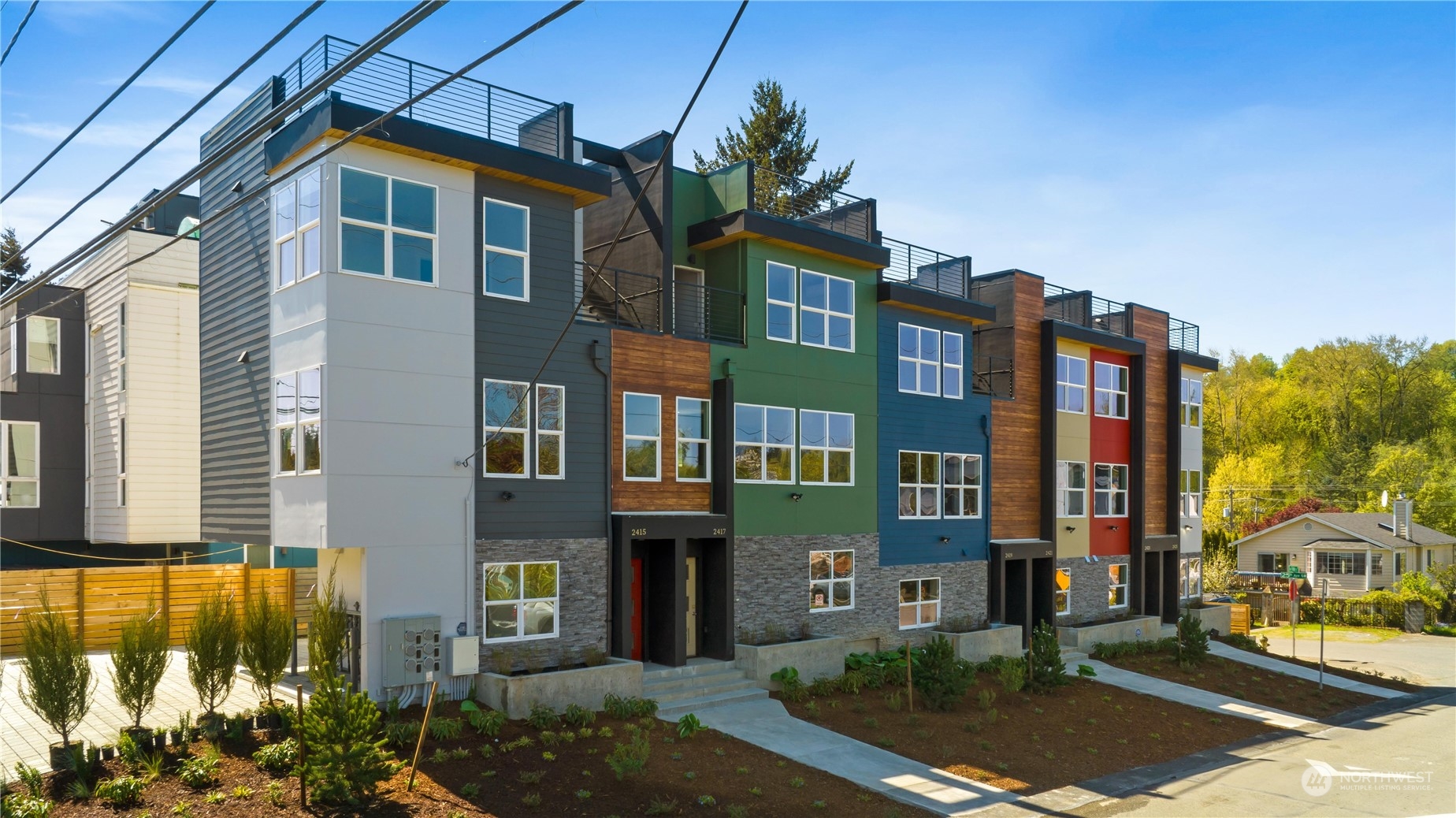 a front view of a residential apartment building with a yard