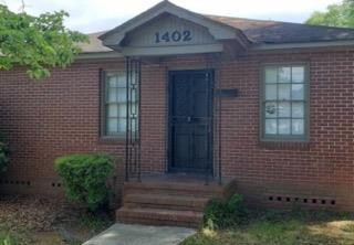 a front view of a house with plants