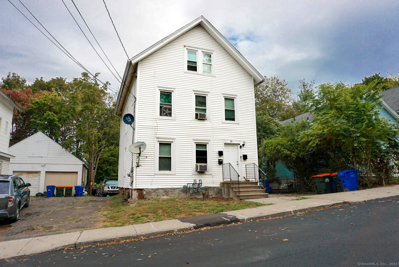 a view of a white house with a street