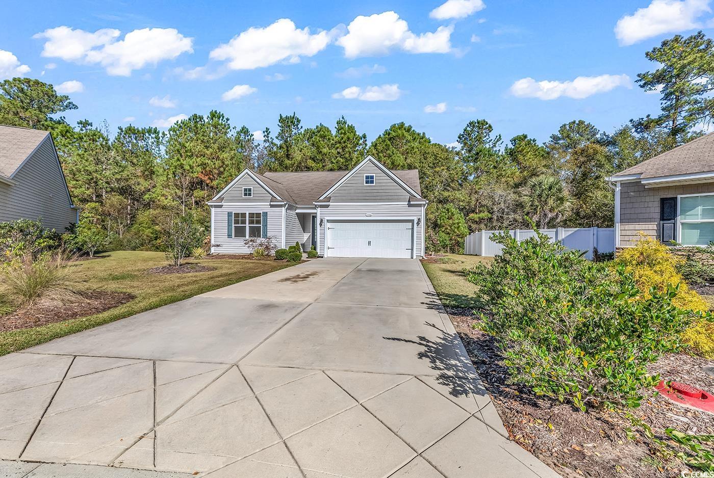 Ranch-style home with a front lawn and a garage