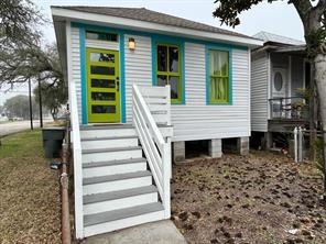 a view of a house with a yard and stairs