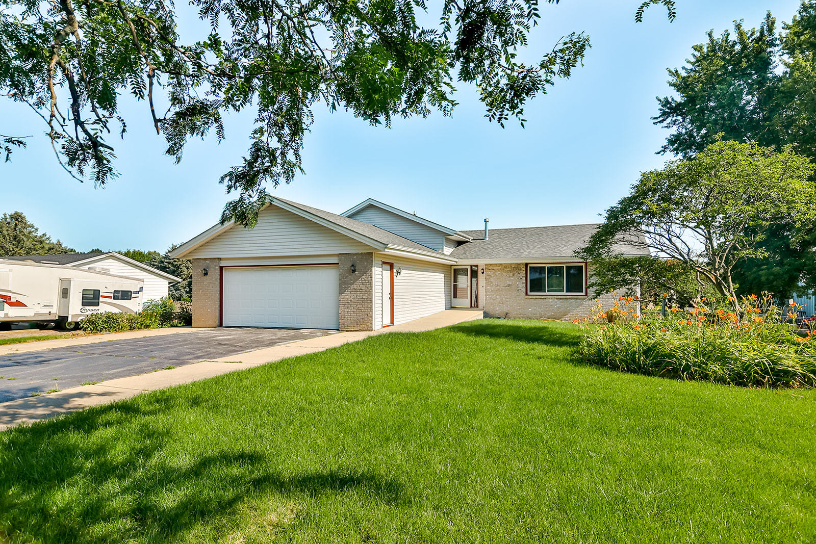 a front view of a house with a yard and garage