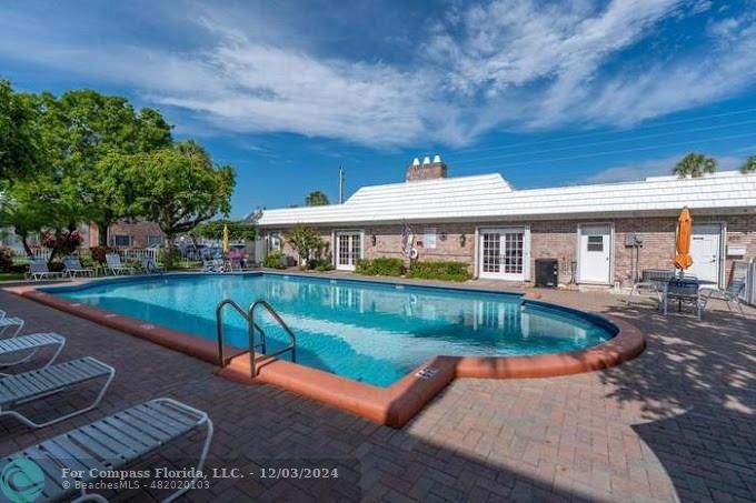 a view of a house with pool yard and a patio