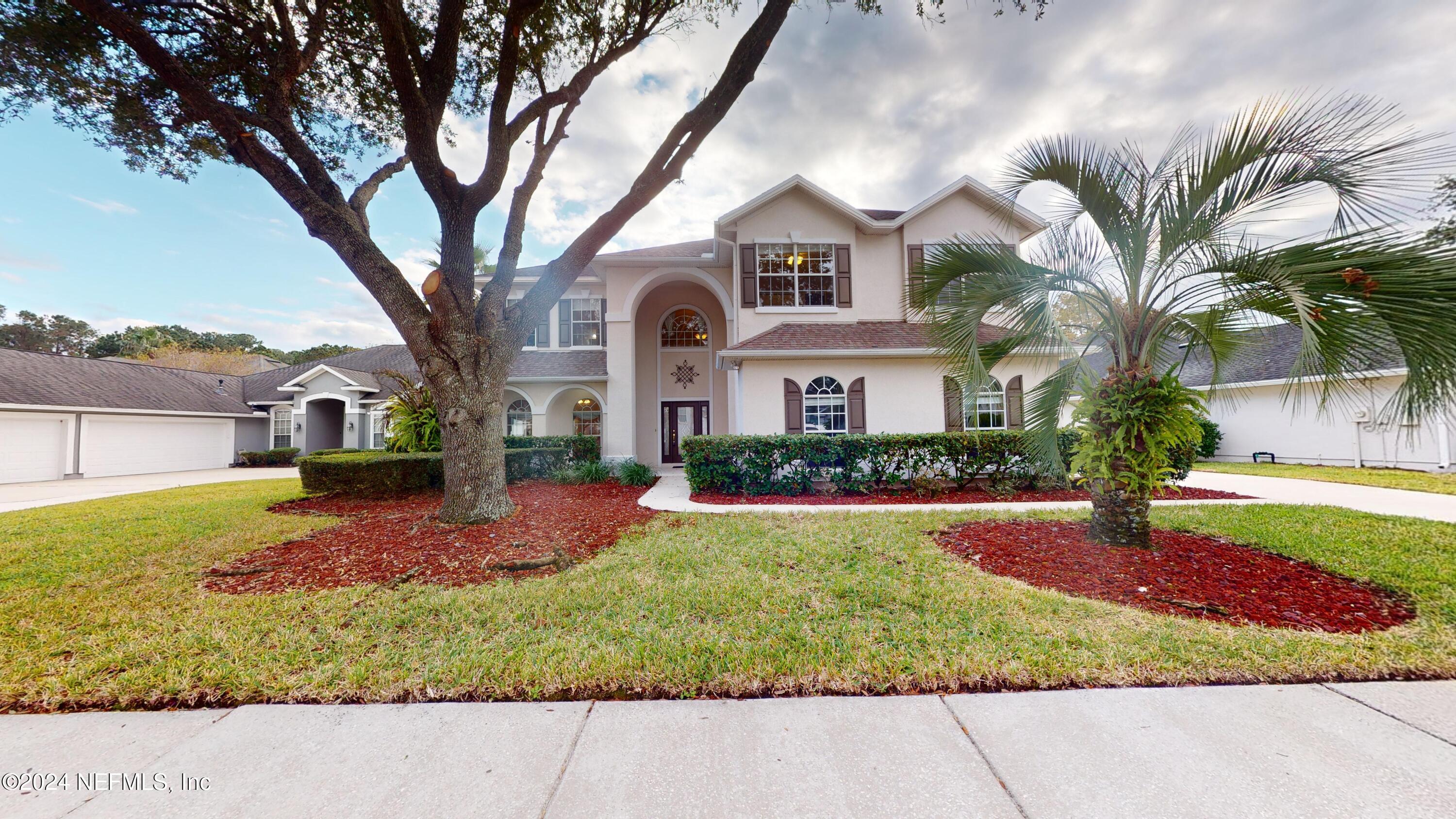 a front view of a house with a yard and garage