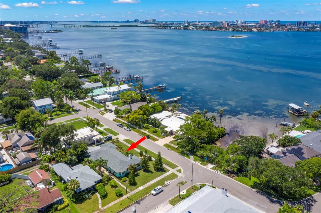 an aerial view of a house with a garden and lake view