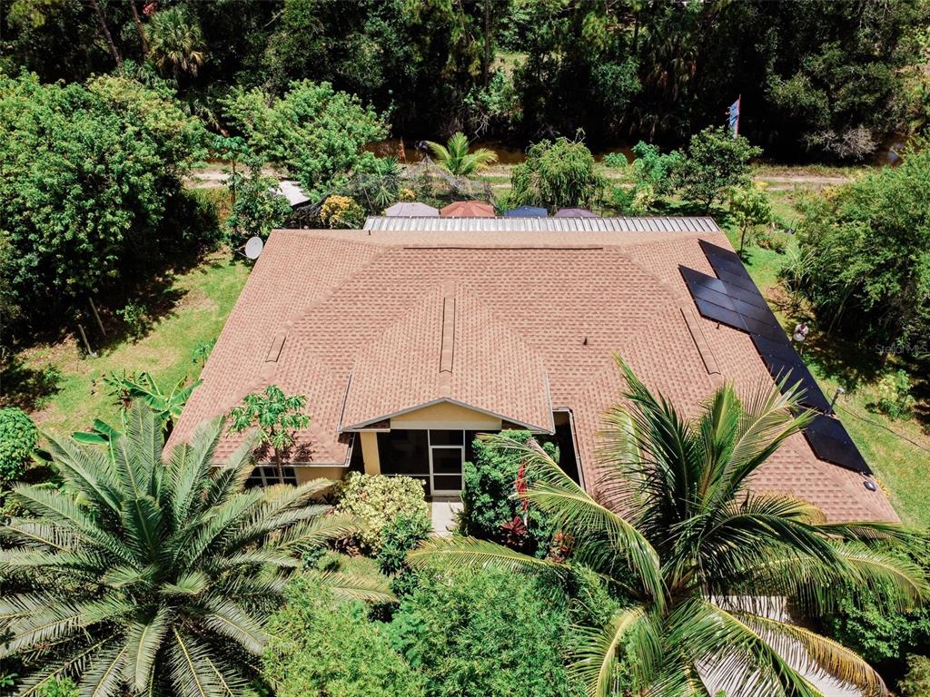 an aerial view of a house with garden space and a yard