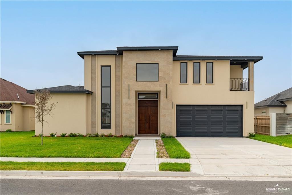 a front view of a house with a yard and garage