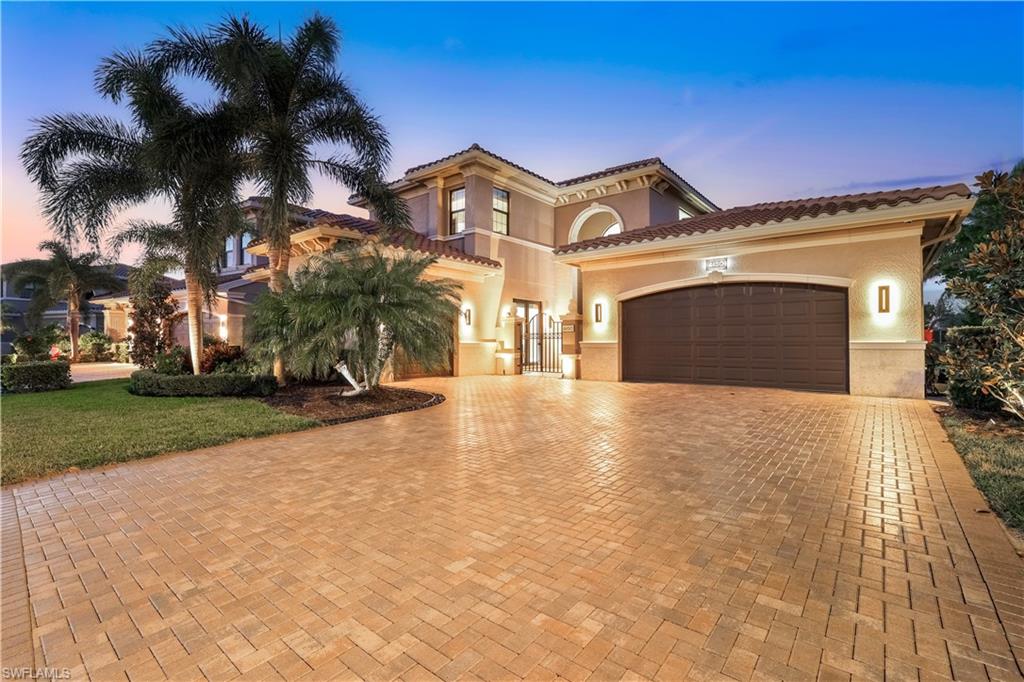 Mediterranean / spanish house featuring a garage and a yard