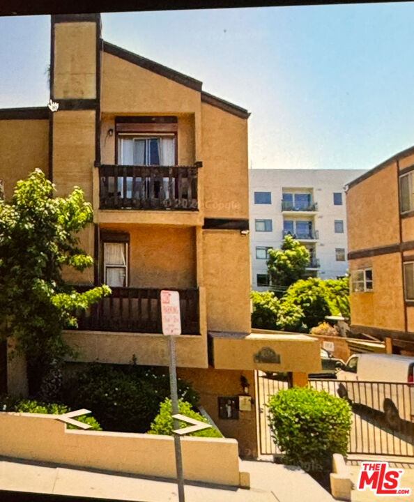 a front view of a building with a garden