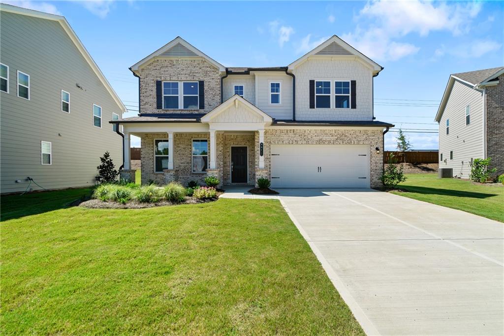 a front view of a house with a yard and garage