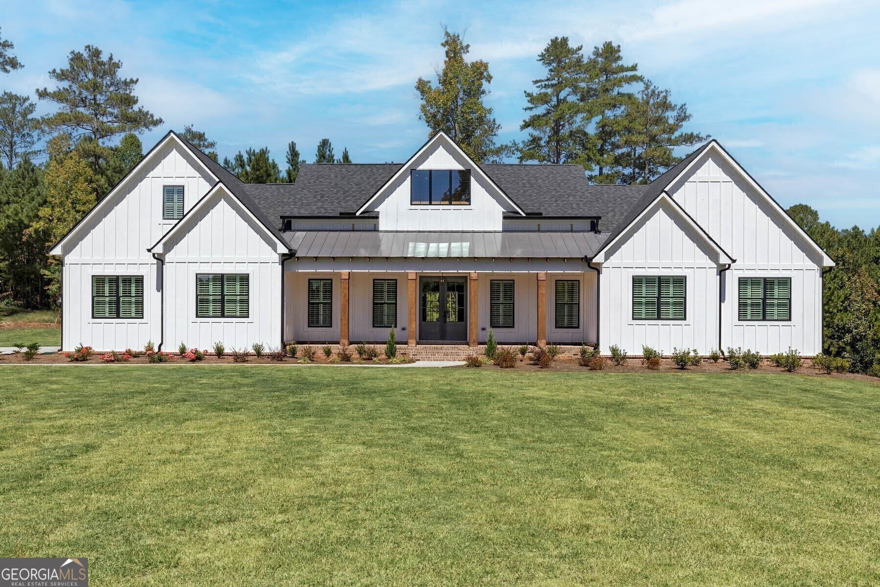 a front view of a house with a garden