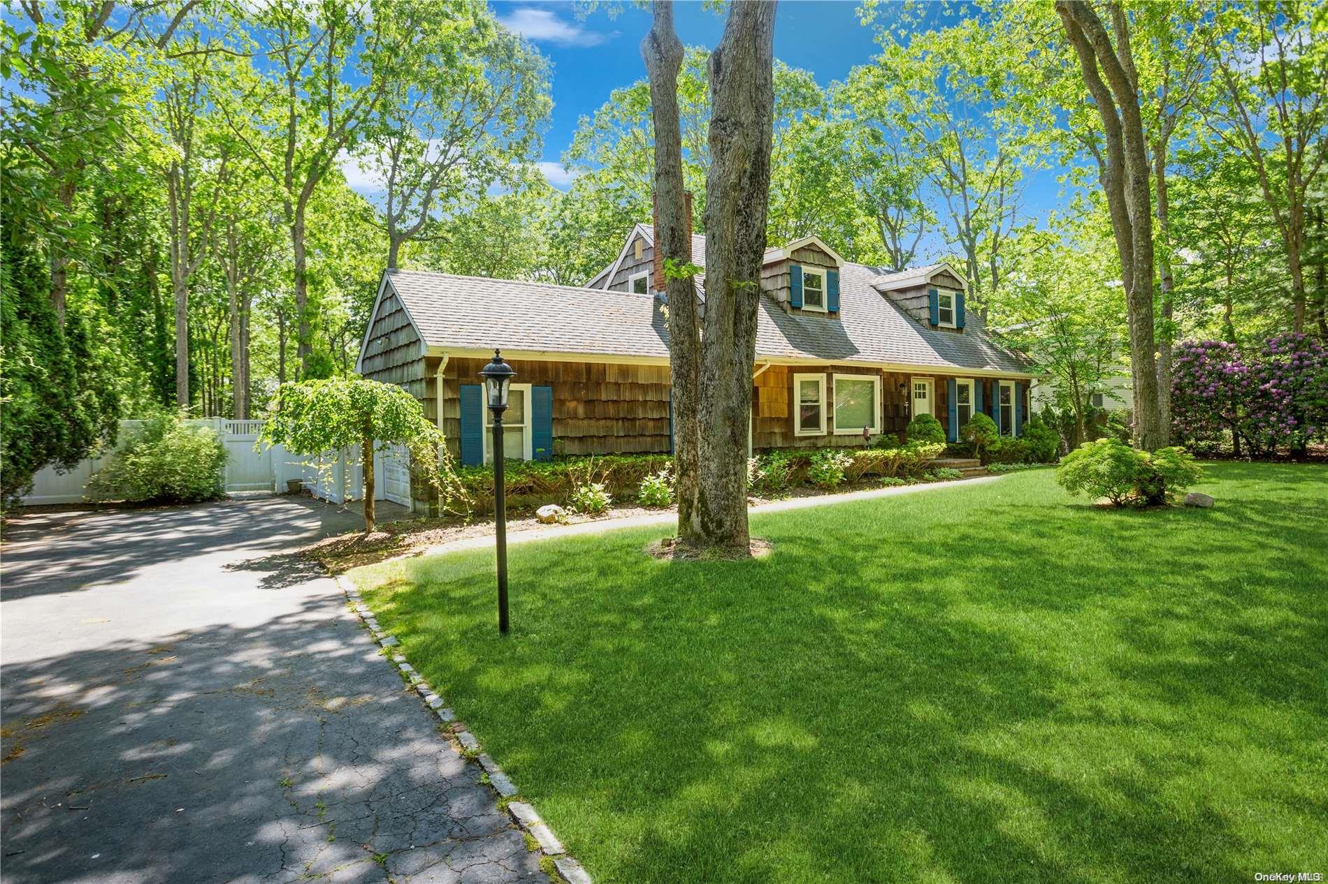 a view of an house with backyard and a tree