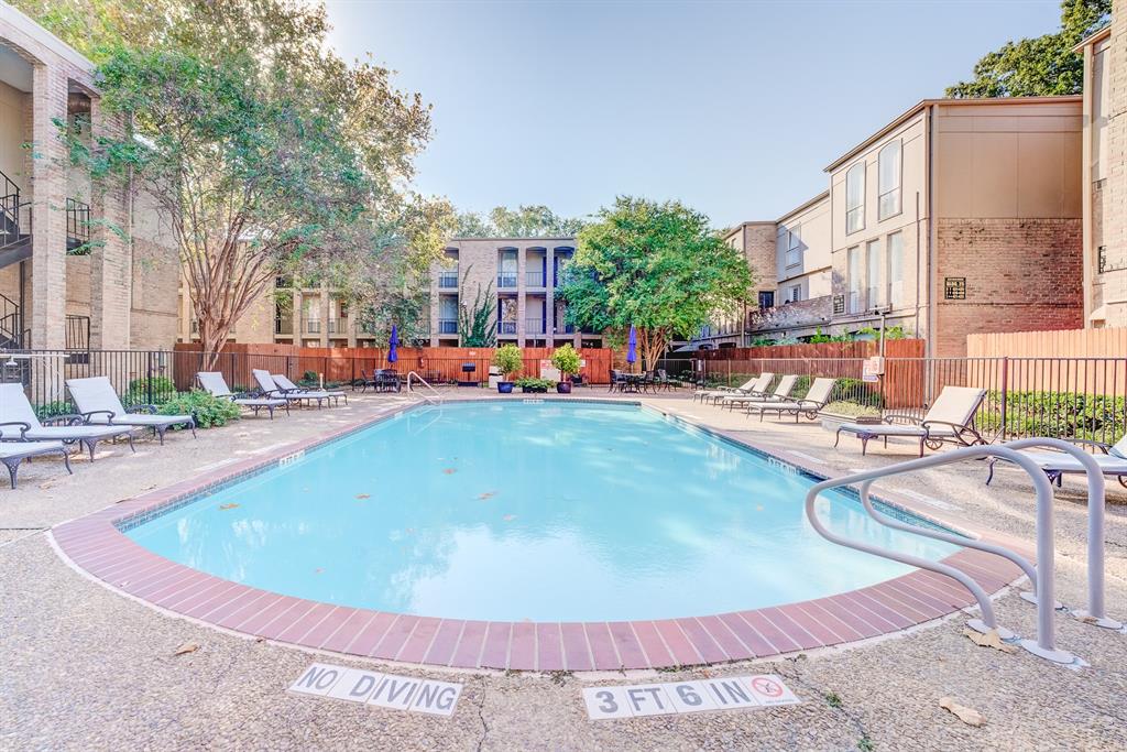 a view of a swimming pool with outdoor seating