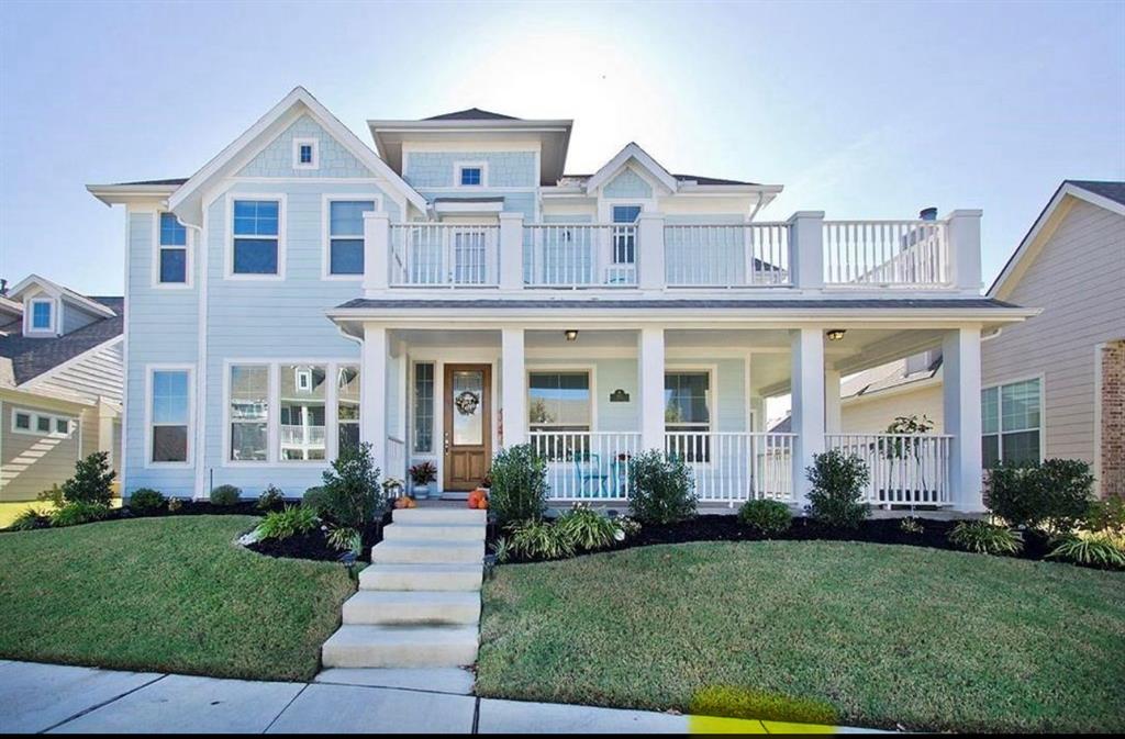 front view of a brick house with a yard