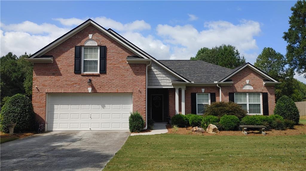 a front view of a house with a yard and garage