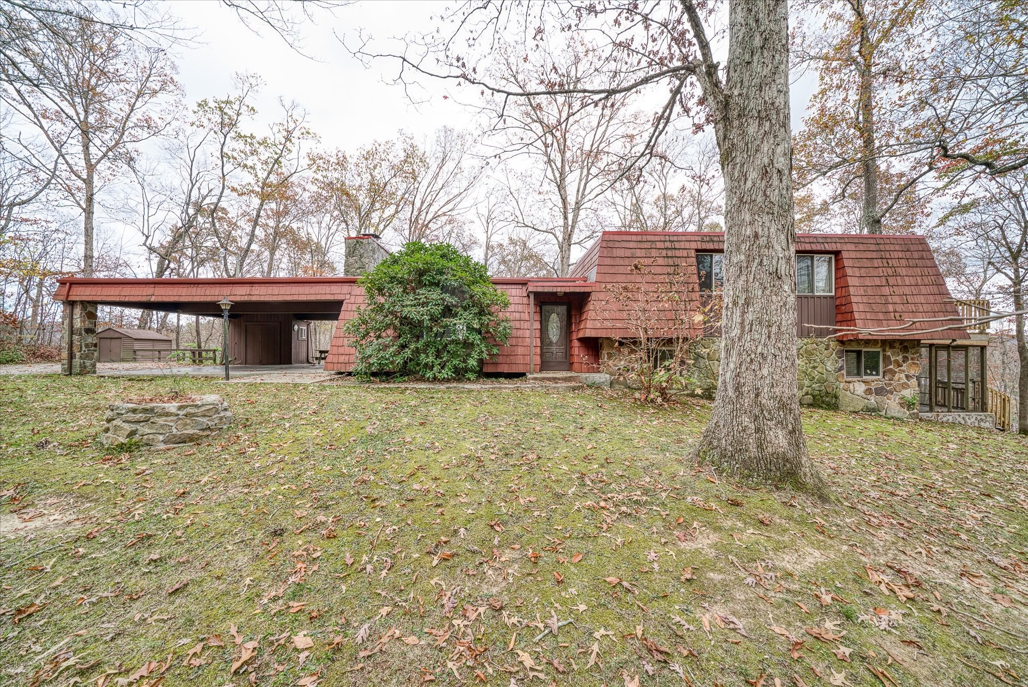 front view of a house with a yard and an trees