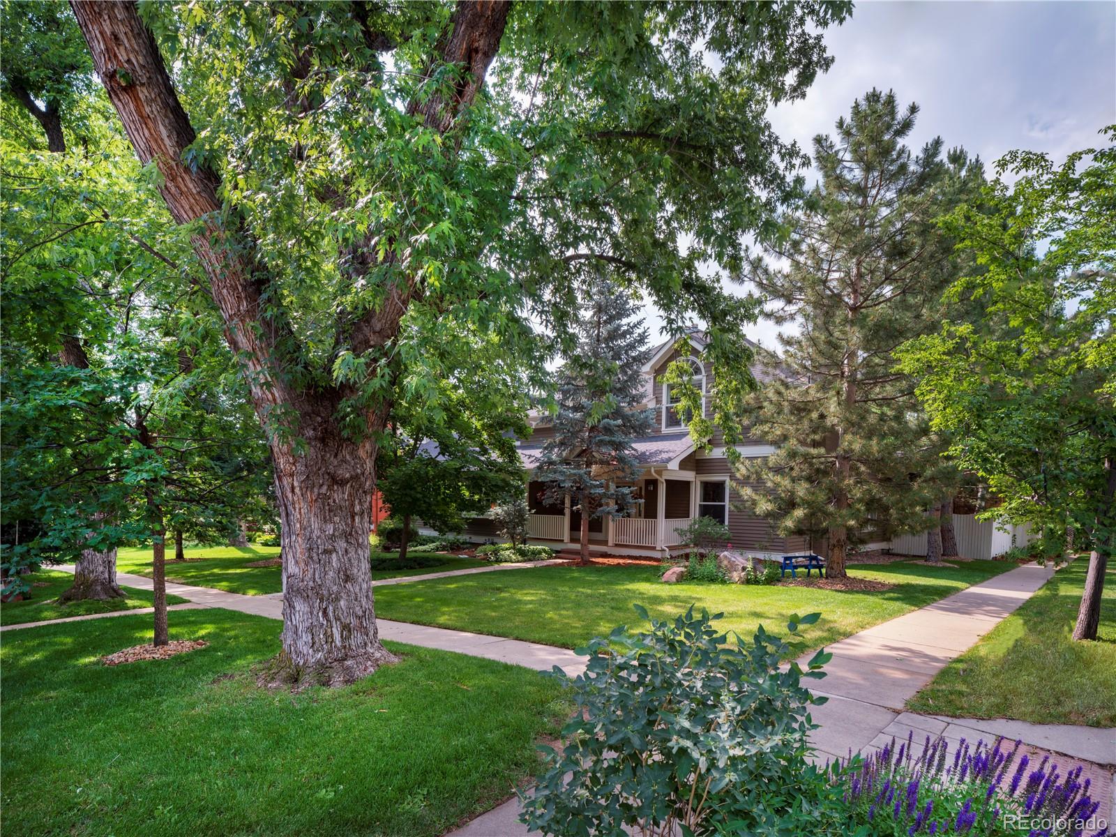 a view of house with swimming pool and yard